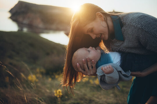 Woman and baby in nature. Mom and baby are relaxing in the park. High quality photo