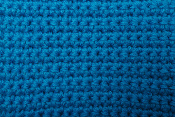 Knit blue fabric texture, background or backdrop. Textile, scarf or sweater textured surface. Warm accessories, clothing, fashion concept