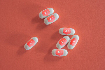 Still life of white pills with social media symbols. - 502349939