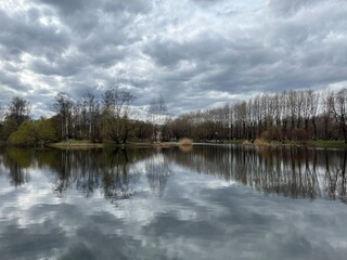 Sky and trees reflection on the lake surface