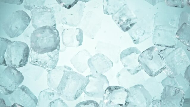 Super slow motion of falling ice cubes separated on blue background. Filmed on high speed cinema camera, 1000 fps.