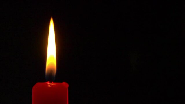 A red candle burning steadily, seamless loop, slow motion, CU