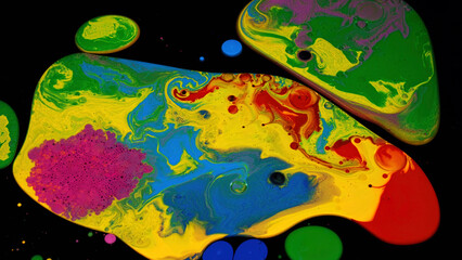 Surface with acrylic ink stains of red, green, blue, pink, an yellow colors. Stock footage. Close up of liquid paints mixing isolated on black background.