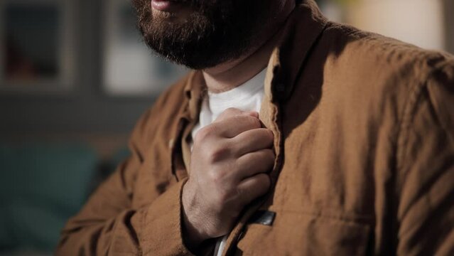 Chest pain. Close-up of man hand with chest pain. Heart attack or tachycardia in bearded middle-aged man