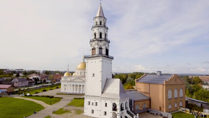 Obraz premium Top view of beautiful temple with Golden domes and bell tower in summer. Stock footage. Golden domes of light temple with bell tower stand out on background of summer town