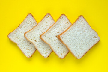 Sliced bread isolated on yellow background. Toast loaf of wheat bread sliced isolated on beautiful background. Flat lay.