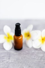 natural beauty and organic ingredients in skincare, amber skincare bottle with flowers in the background