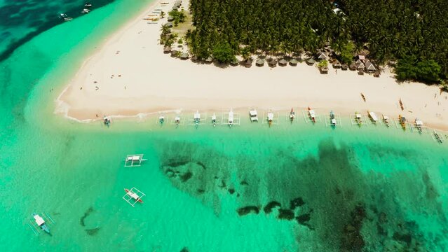 Sand beach and tropical islands, palm trees by atoll with coral reef, top view.Daco island, Philippines. Summer and travel vacation concept