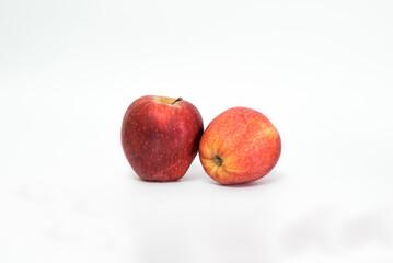 Fototapeta na wymiar Two juicy ripe red apples isolated on white background. Healthy food.