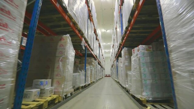 Large modern warehouse with goods without people. The camera moves through the factory warehouse. Modern warehouse, industrial interior