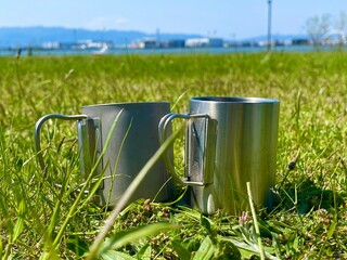 watering can in grass
mag
pair 
grass 
green 
park 
camp 
day camping...