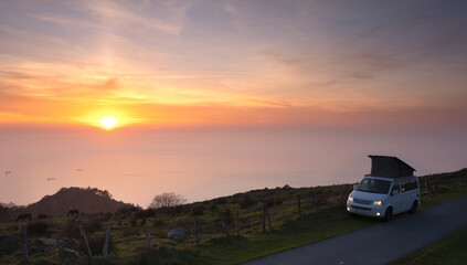 Van at sunset over the sea on mount Jaizkibel, Euskadi