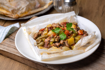 Traditional Turkish food; Meat with vegetables wrapped in greaseproof paper, kebab (Turkish name; Sebzeli kagit kebabi)