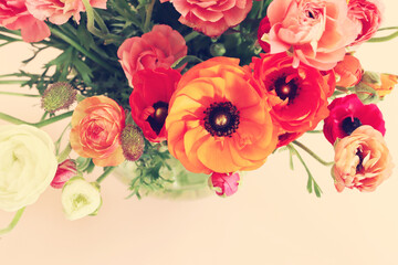 Top view image of colorful flowers composition over pink pastel background