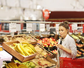 Woman buying fruits and vegetables at the market