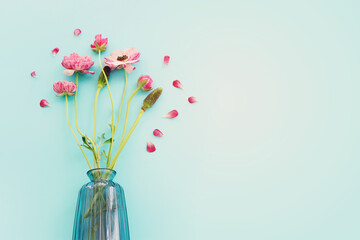 Top view image of pink flowers composition over blue background