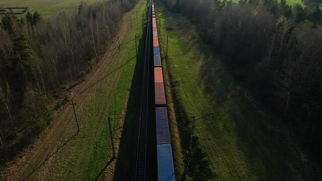 Shipping containers transportation on freight train by railway. Cargo Containers On Railroad. Intermodal Container On Train Car. Rail Freight Shipping Logistics. Multimodal Freight Transportation.