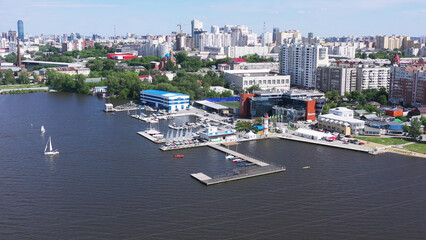 View on the boat parking at the yacht club. Video. Beautiful aerial view of marine club with sailing and moored yachts near the pier, water sport and transportation concept.