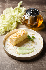 Piece of cake Napoleon puff pastry with custard cream. Russian cuisine, multi layered cake with...
