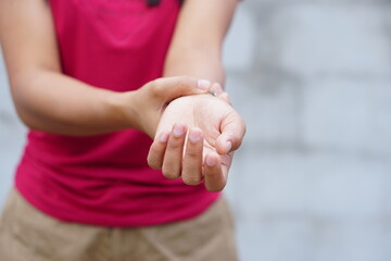 Woman holding her wrist pain from using computer, office syndrome