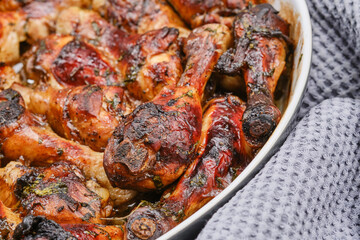 Hot homemade chicken with balsamic vinegar sauce in a baking dish. Shallow depth of field