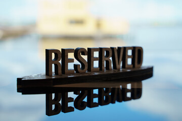 Wooden word reserved sign in cafe or restaurant 
