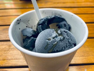 Close-up of bamboo charcoal ice cream cup- exotic food in Asia