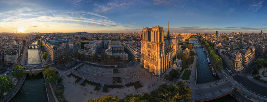 Panoramic aerial view of Notre Dame Basilica at sunset in Paris, France.