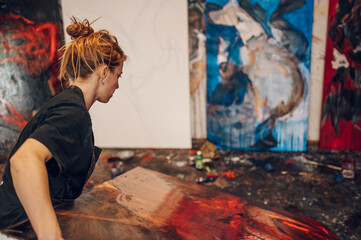 Female painter artist painting and creating her art in a creative studio