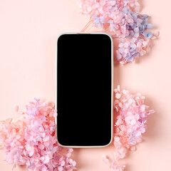 Smartphone mockup with pink flowers on pastel background. Device screen mock up on stylish background for presentation or appl design