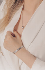 Woman wearing elegant silver necklace and bracelet - obrazy, fototapety, plakaty