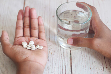 unrecognized man in white shirt taking medicine 