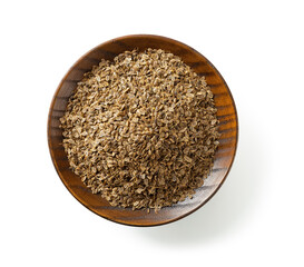 Organic dill seeds on a wooden saucer isolated on a white background. Cutout of whole anethum graveolens fruits on a plate. Natural spices, condiments and seasonings. Medicinal herb.