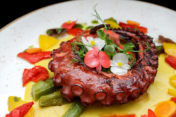 Grilled octopus tentacles with asparagus and sauce
