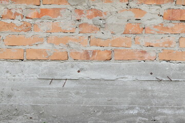 Texture of concrete with brick wall. Brick wall vіlozhina on the foundation.
