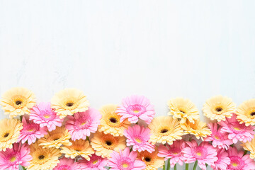 Obraz premium Pink and yellow gerberas on a white wooden background. Mothers Day, Valentines Day, birthday concept
