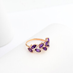 gold ring with gemstones on white background