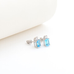 earrings with colos gems on white background