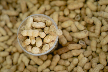 shelled peanuts lie in a glass