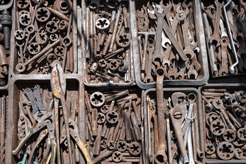 close-up showcasing old rusty metal and brass parts in bulk for decoration or collection, sold at a flea market or garage sale for an antique collection