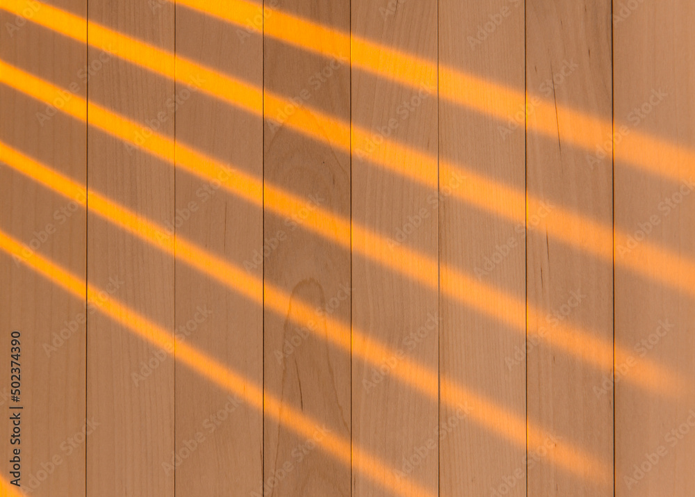 Wall mural Wooden surface as background texture with rays of light.