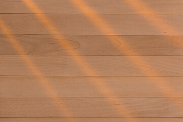 Wooden surface as background texture with rays of light.