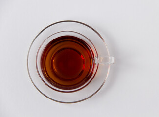 Cup of black tea top view on a white background. 