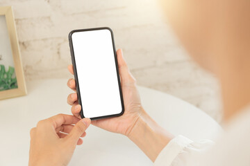 cell phone blank white screen mockup.hand holding texting using mobile on desk at office.background empty space for advertise.work people contact marketing business,technology