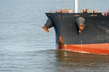 Front view of large blue container cargo ship. Performing cargo export and import operation.