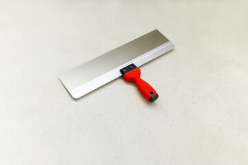 Clean trowel on concrete floor, close up. Construction finishing works