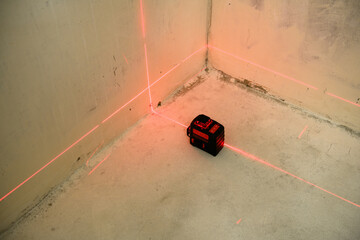 Red Laser level turned on in a dark room