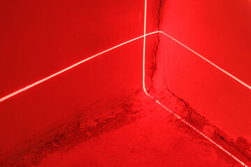 Red laser beams in a room with red lighting