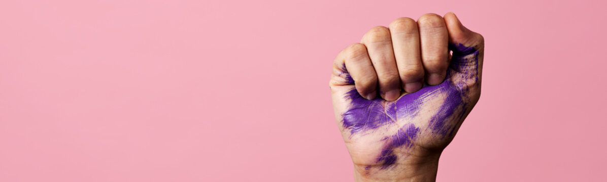 raised fist with purple paint, web banner