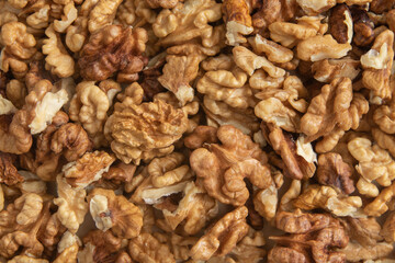 Peeled walnuts top view. Food abstract background with nuts